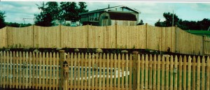 Cedar scalloped privacy fence with spaced picket fence in front
