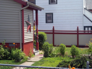 Vinyl grand illusions mix and match fence sections set to match house and trim with gothic post caps